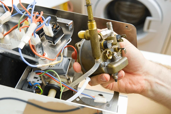 Catering equipment spare parts - technician working on kitchen equipment gas valves and controls